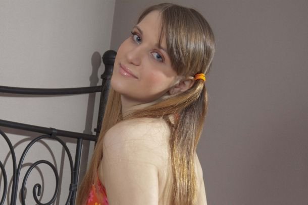 portrait picture of molly appearing topless with small breasts